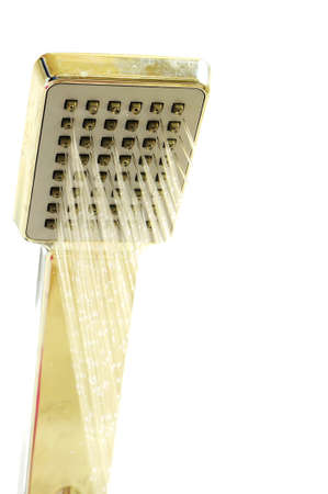 Shower nozzle in use on a white backgroundの写真素材