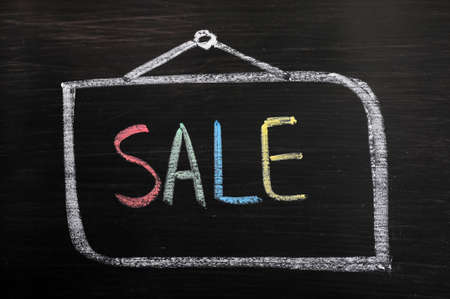 Word sale written on a blackboardの写真素材