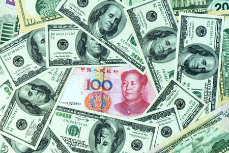 Pile of USD and RMB bank notes as money backgroundの写真素材