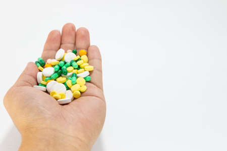 Select  focus. Closeup of medicine pills, capsules and antibiotic medicine on the hands of the doctor. On white background. Clipping path version.の写真素材