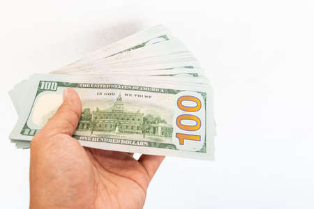 Close up of stack hundred new US dollar on hand Money American isolated on white background.の写真素材