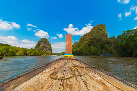 Wooden boat in the river going to KHAO KHA NAB NAM (THE RIVERSIDE PARALLEL MOUNTAINS) in KRABI...