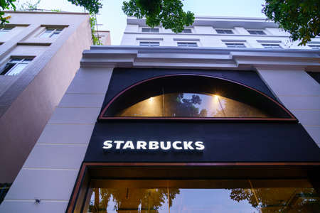 HANOI/VIETNAM - JULY 16: Logo starbucks coffee shop and a meeting that teenagers like to gather...