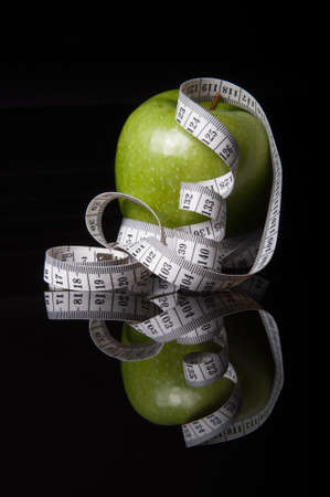 green apple surrounded by white tapelineの写真素材