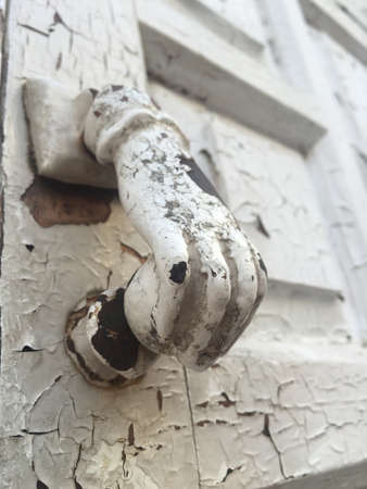close up hand shaped knob of a wooden door