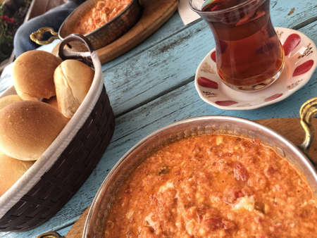traditional breakfast with omelet and turkish tea on wooden tableの写真素材