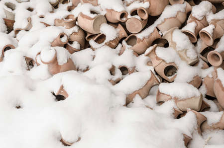 Handmade potteries covered with snow in winterの写真素材