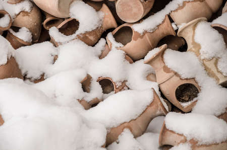 Handmade potteries covered with snow in winterの写真素材
