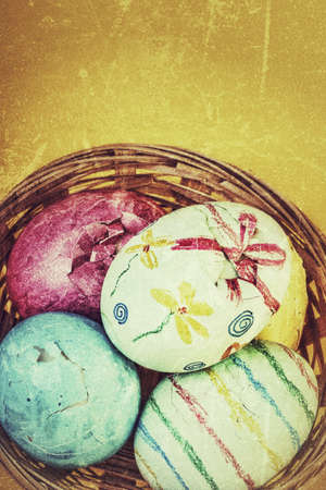colorful broken easter eggs in a basket with copy spaceの写真素材