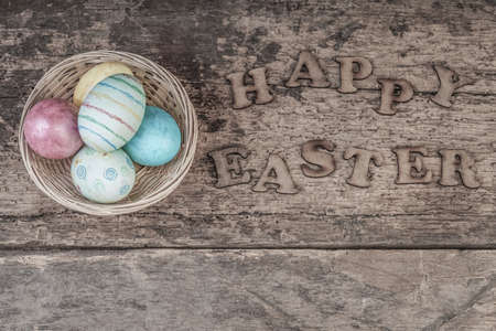 Easter template with colorful eggs on wooden background