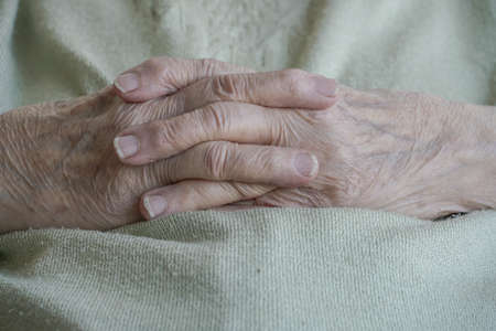 closeup wrinkled hands of a senior woman