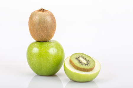 kiwi and apple on white with reflectionのeditorial素材