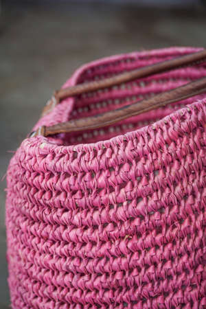 closeup of a handmade pink wicker bagの写真素材