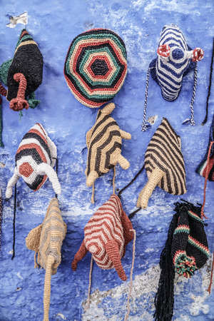 Colorful knit hats hanged on wall in Morocco