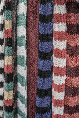 Colorful knitted scarfs as a background