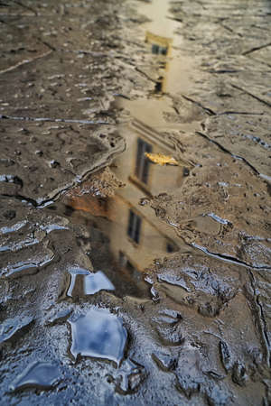 reflection of a building on a puddle of water in Italy