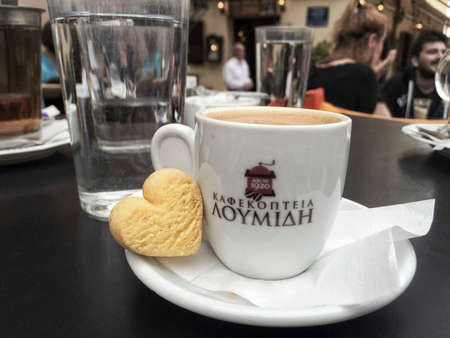A cup of Greek coffee on table in a cozy open air cafe at Plaka district of Athens in Greece.のeditorial素材
