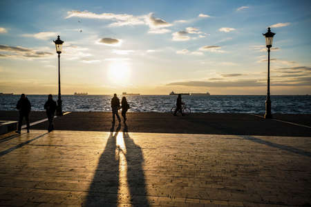 People walking at sunset in Thessaloniki, the second-largest city in Greece.の写真素材