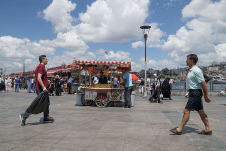 Eminonu district with many facilities to eat such as floating restaurants and carts with fresh bakery, hot corn or roasted chestnuts in Istanbul, Turkey.のeditorial素材