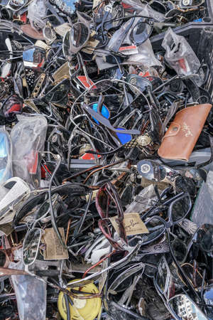 Cluster, pile of old sun glasses that are new and some used second hand for sale at flea market in...