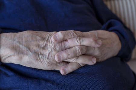Closeup wrinkled hands of a senior personの写真素材