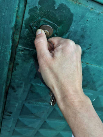 closeup female hand locking a door