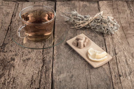 A cup of natural sage tea on wooden tableの写真素材