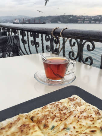 breakfast and tea on table by sea in Istanbul, Turkey