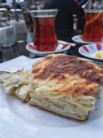 Tea and patty for a traditional turkish breakfast on tableの写真素材
