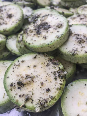 Fresh and raw zucchini slices as a backgroundの写真素材