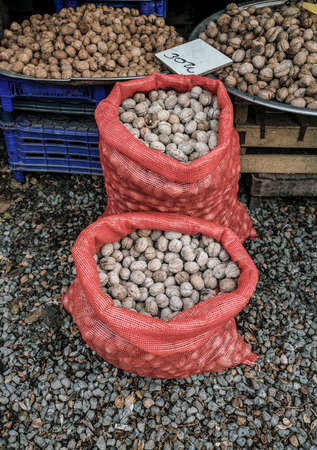 walnuts in red bags to sell in a farmers marketの写真素材