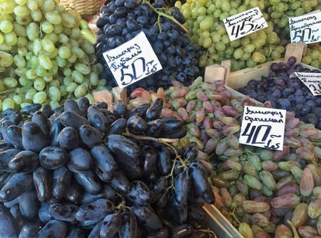 Variety of grapes at market in Ukraine with Ukrainian labelsの写真素材