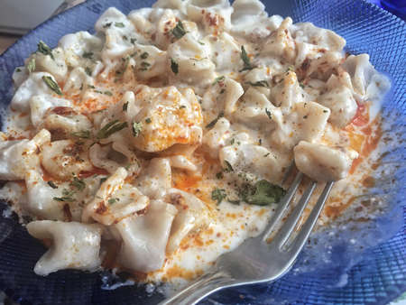 Closeup of turkish ravioli on a blue plateの写真素材