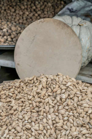 Pile of shelled almonds with price tag in a market