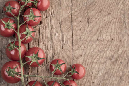 Ripe cherry tomatoes on wooden tableの写真素材