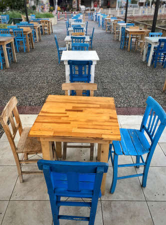 Old wooden table and chairs in an open air cafe in Turkeyの写真素材