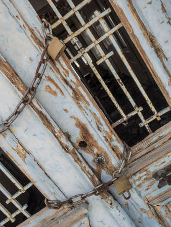 Locked wooden door of an abandoned building