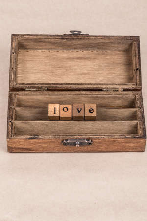 Love written with wooden block letters in a box