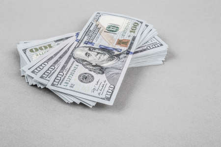 American Dollar stacks on grey with copy space