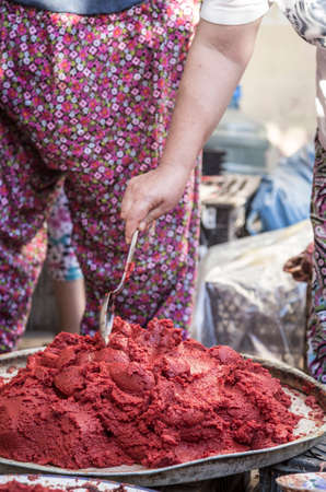 Preparing homemade tomato paste in Turkey for winterの写真素材