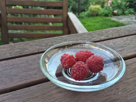 ripe raspberry fruits on table at gardenの写真素材