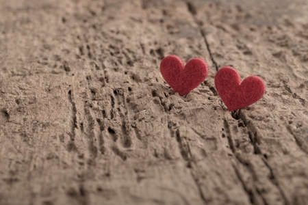 small red hearts on wooden background with copy spaceの写真素材