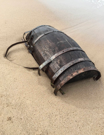 A wooden barrel on a sandy beachの写真素材