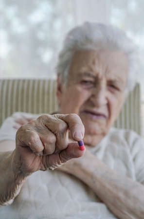 A senior woman holding a pillの写真素材