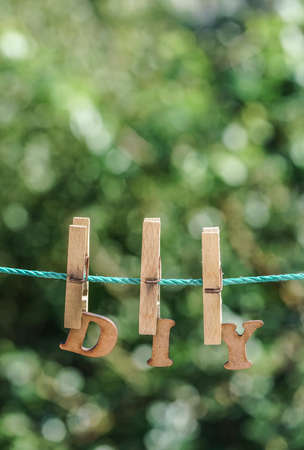 D.I.Y. word written by hanged wooden letters on rope at garden in springの写真素材