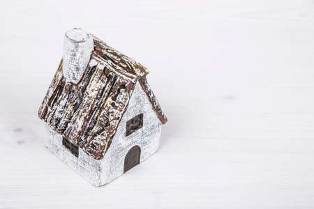 A small house on a wooden surface with copy spaceの写真素材