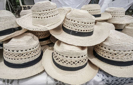 pile of straw hats as a background