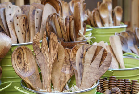wooden spoon and forks on sales with other utensils kitchenware on display shelfの写真素材