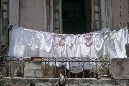 hanged clothes at balcony of an apartment to dry in Cubaの写真素材