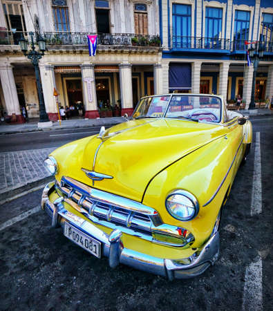 A yellow Classic American car parked at the center of Havana, Cuba.のeditorial素材
